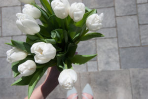 One way to welcome spring into your home Girl Holding white tulips 